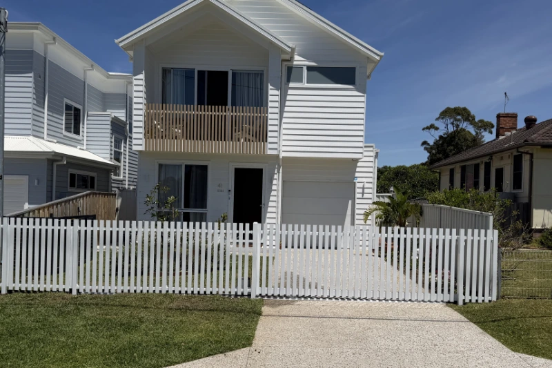 White aluminium fencing picket style in front of a residential home — Muller's Fencing Sydney